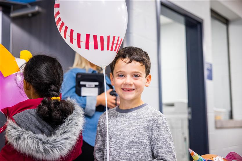 Students participate in a balloon parade